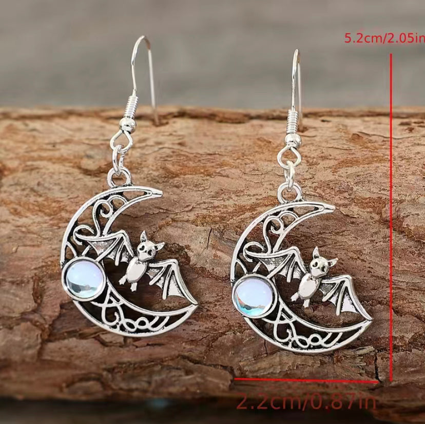 Celestial earrings, Bat silhouette, Gothic jewelry, Lunar-inspired, Night sky accessory, Crescent moon design, Mystical charm, Statement earrings, Elegant adornment, Intricate detailing, Lightweight jewelry, Versatile wear, Dark elegance, Handcrafted beauty, Nocturnal allure, Unique accessories Sterling silver, Dangle earrings Witchy fashion, Symbolic jewelry