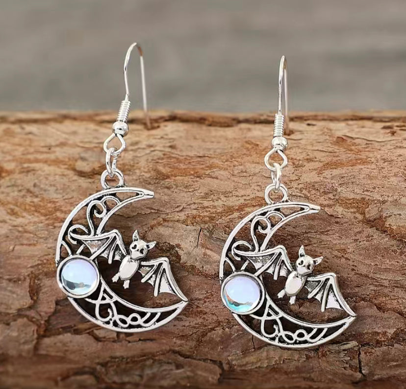 Celestial earrings, Bat silhouette, Gothic jewelry, Lunar-inspired, Night sky accessory, Crescent moon design, Mystical charm, Statement earrings, Elegant adornment, Intricate detailing, Lightweight jewelry, Versatile wear, Dark elegance, Handcrafted beauty, Nocturnal allure, Unique accessories Sterling silver, Dangle earrings Witchy fashion, Symbolic jewelry