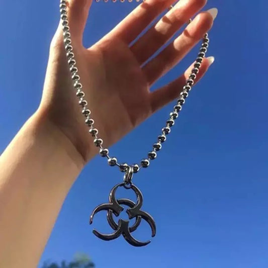 Biohazard, Necklace, Pendant, Edgy, Alternative fashion, Gothic, Statement piece, Symbolic, Intricate design, High-quality, Unique, Bold, Rebellion, Attention-grabbing, Conversation starter, Adjustable chain, Fashion accessory, Hazardous, Urban, Streetwear